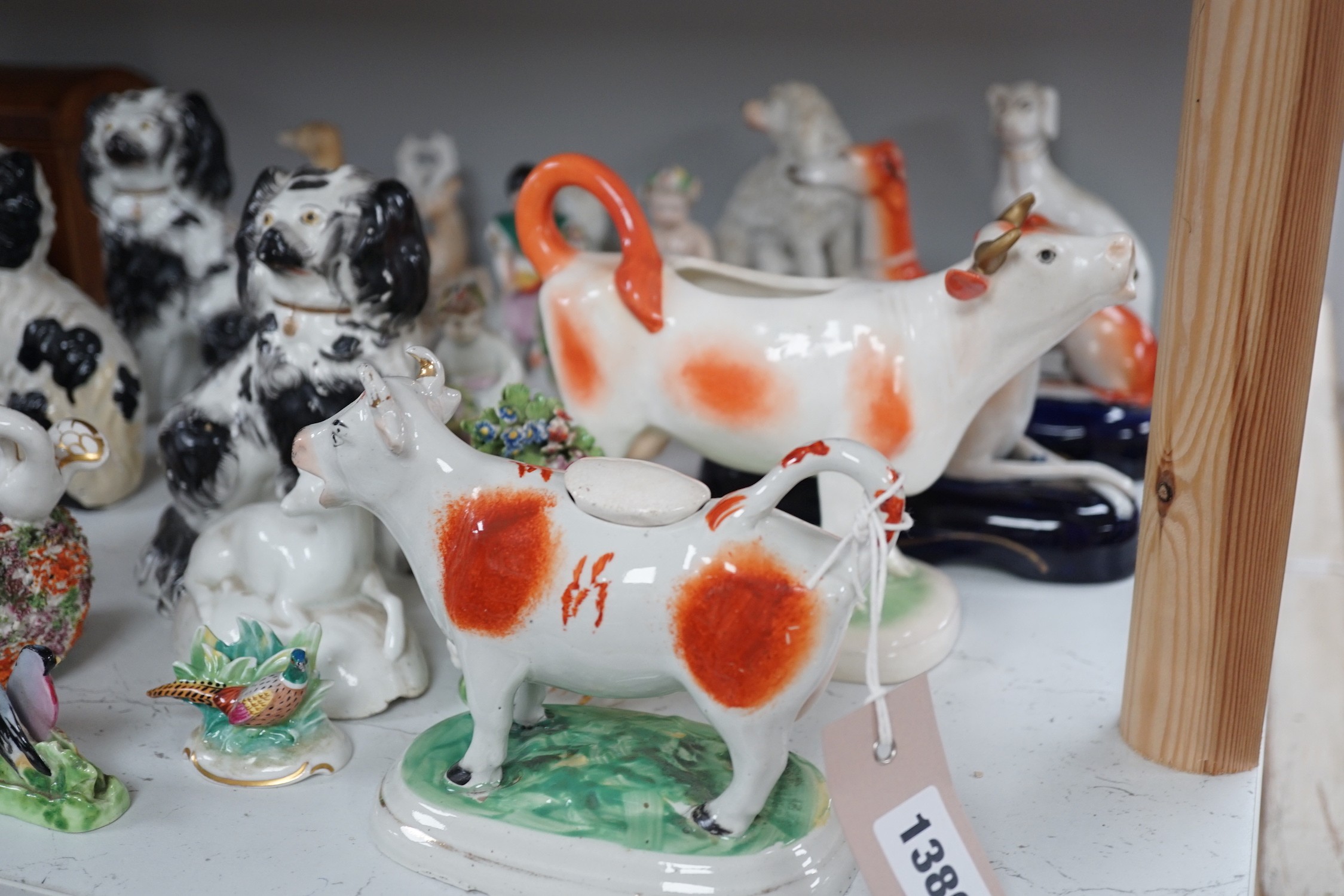 A quantity of Victorian Staffordshire animal figures, two pearlware putti and a Derby figure of a cherub, tallest 14.5 cm